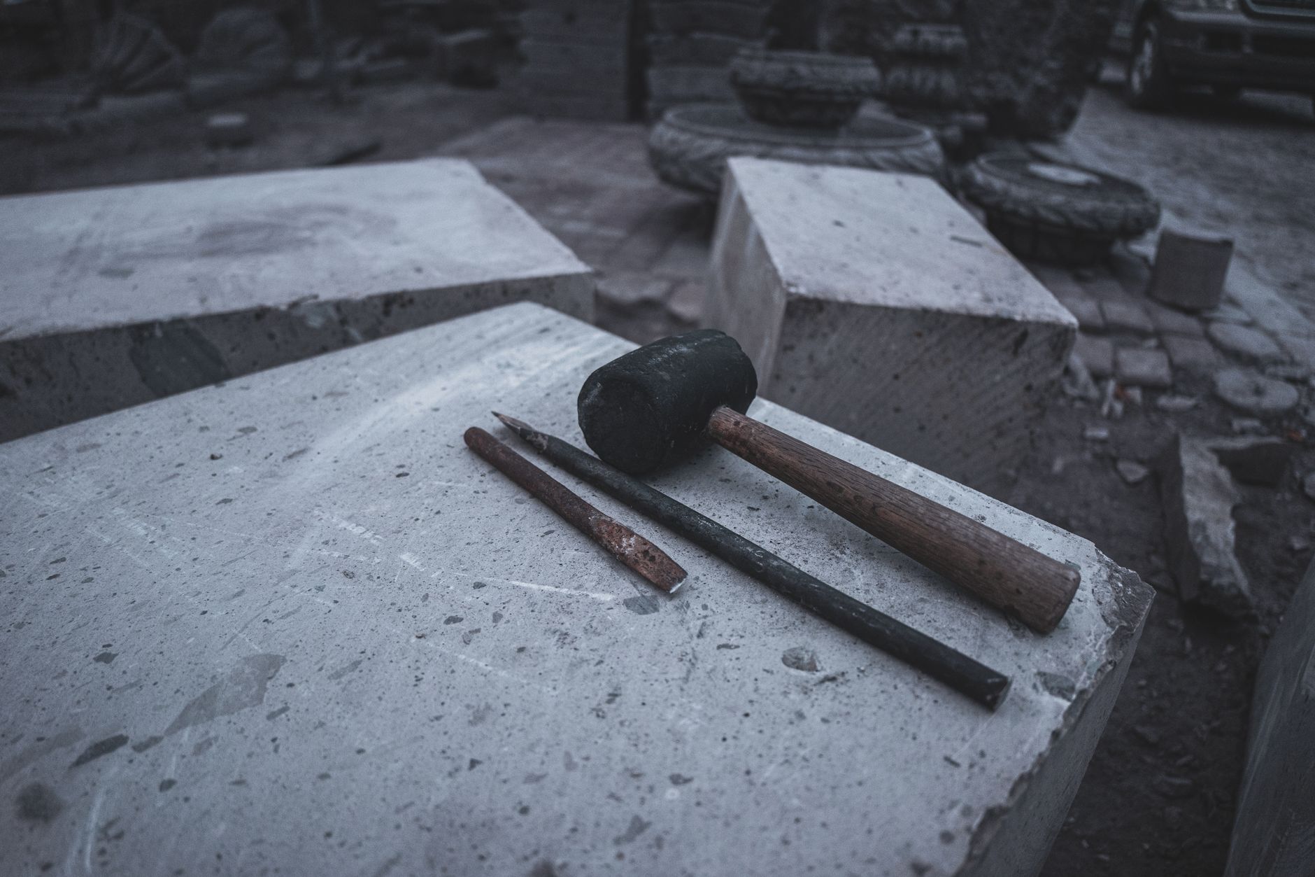 heavy crack hammer and chisel on limestone rock surface outdoors
