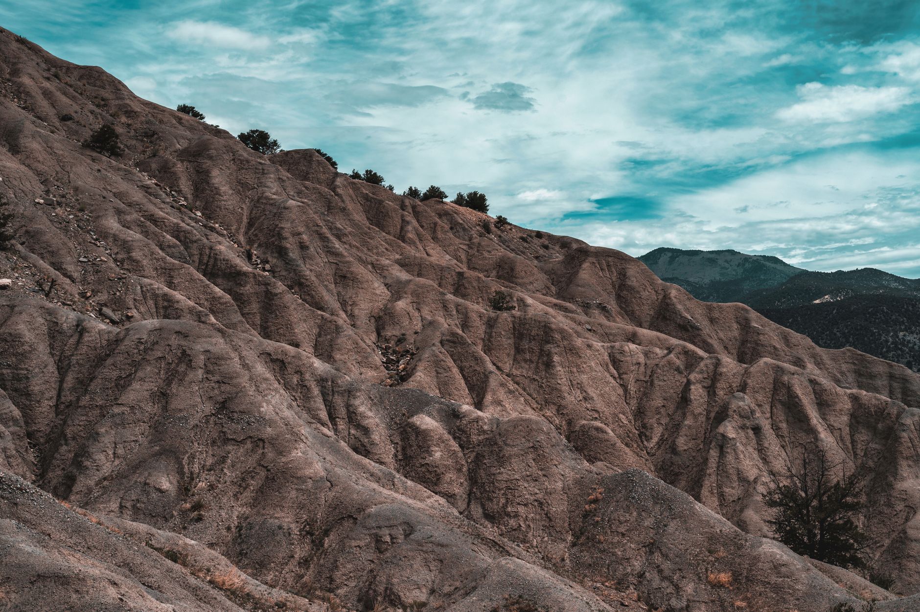 Explore the dramatic geological formations of a rocky landscape under a serene sky.